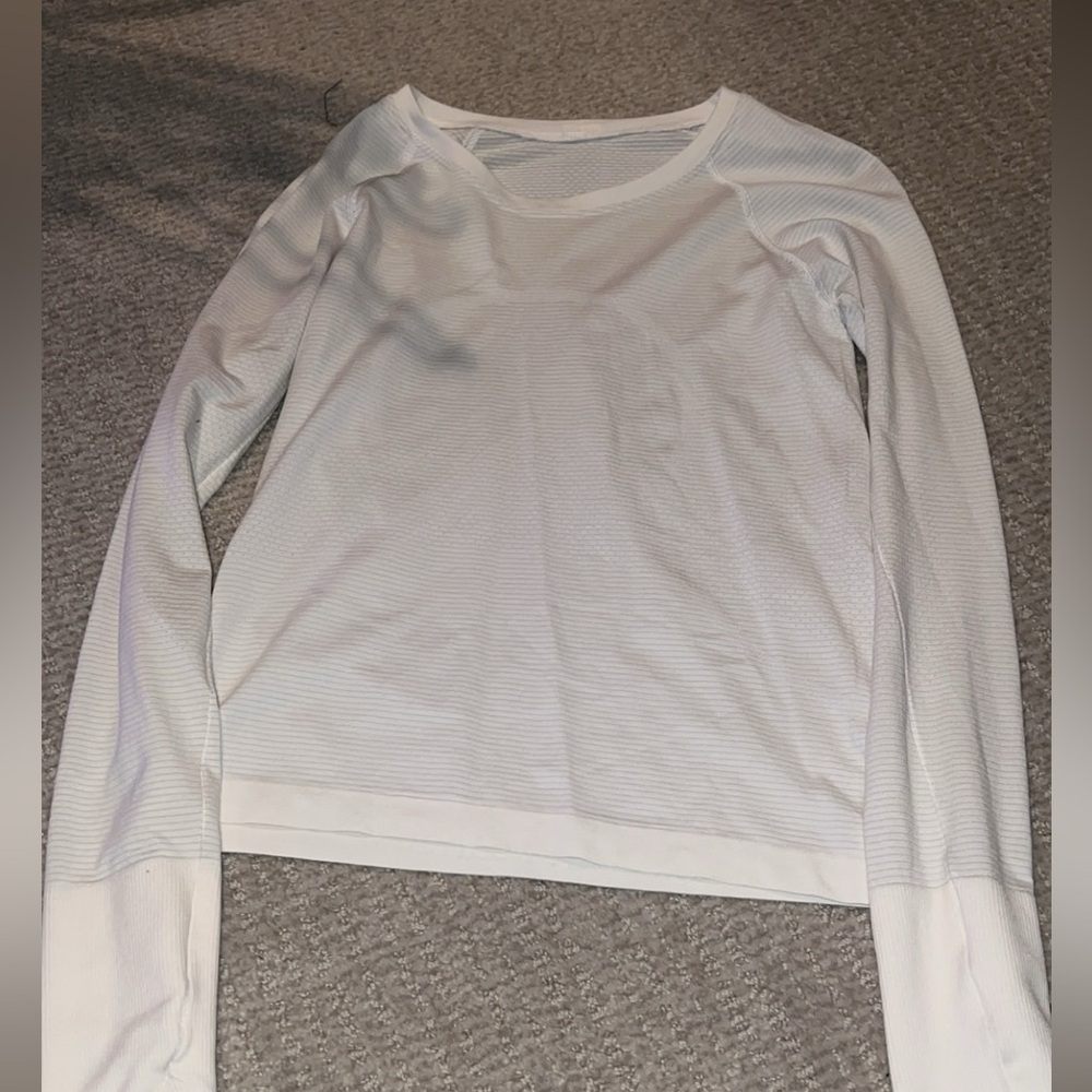 White Long sleeved lululemon swiftly tech/ size:4. (tiny stain on sleeve)